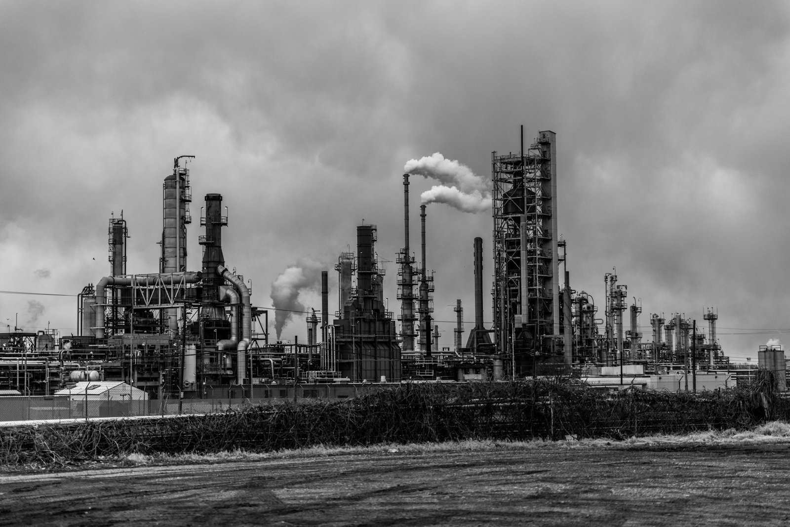 An American refining complex beneath a heavy sky.